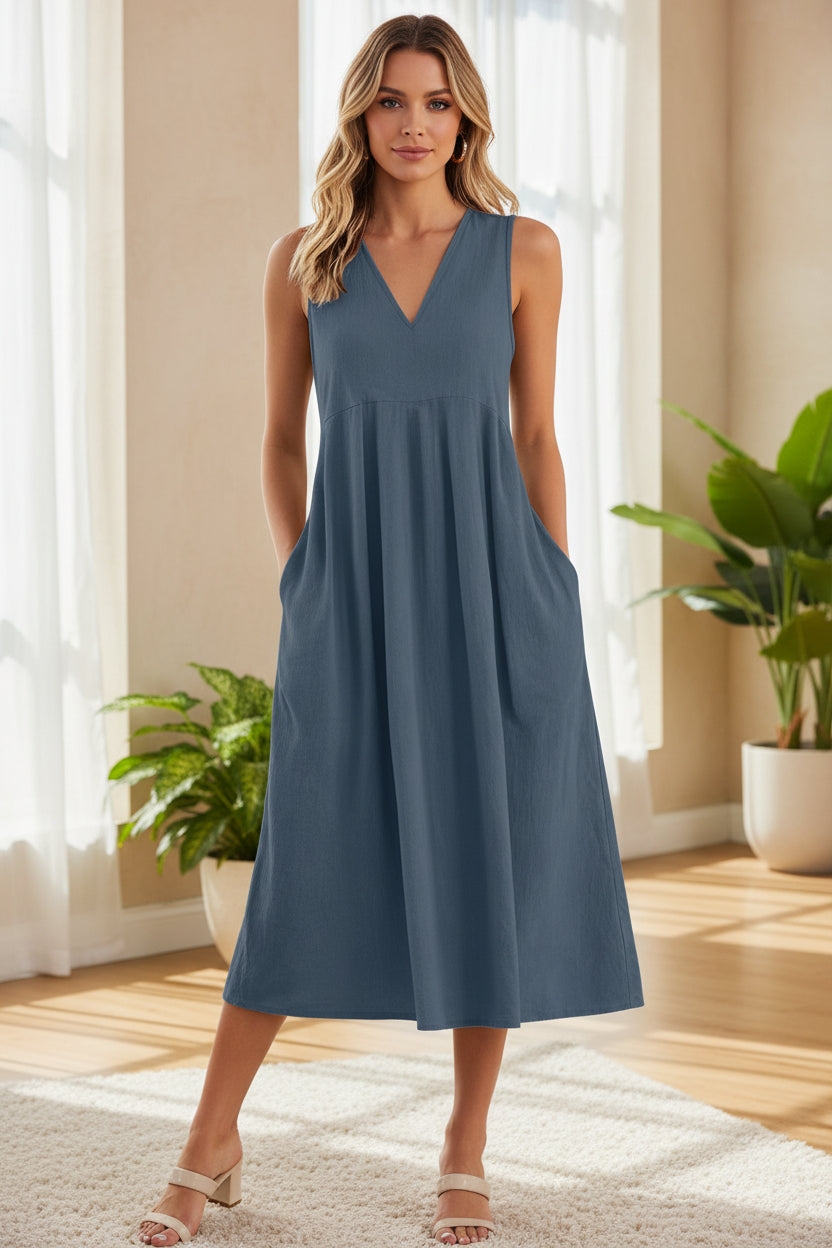 Blue sleeveless dress worn by a person on a white background