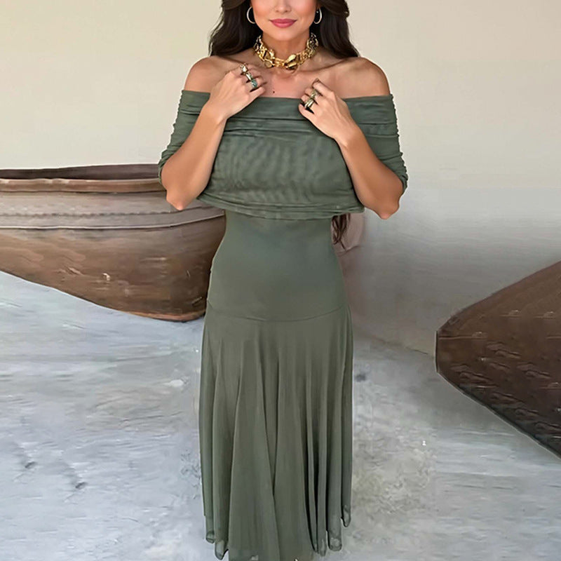 Woman wearing an olive green off-shoulder dress with a neutral background