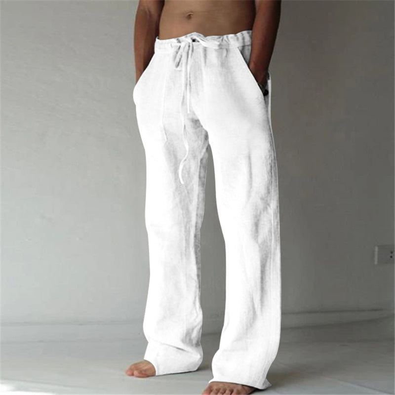 Person wearing white pants against a plain background