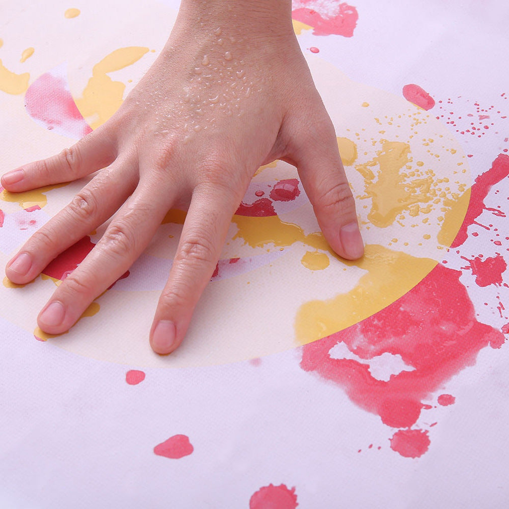 Hand pressing onto a colorful纸上