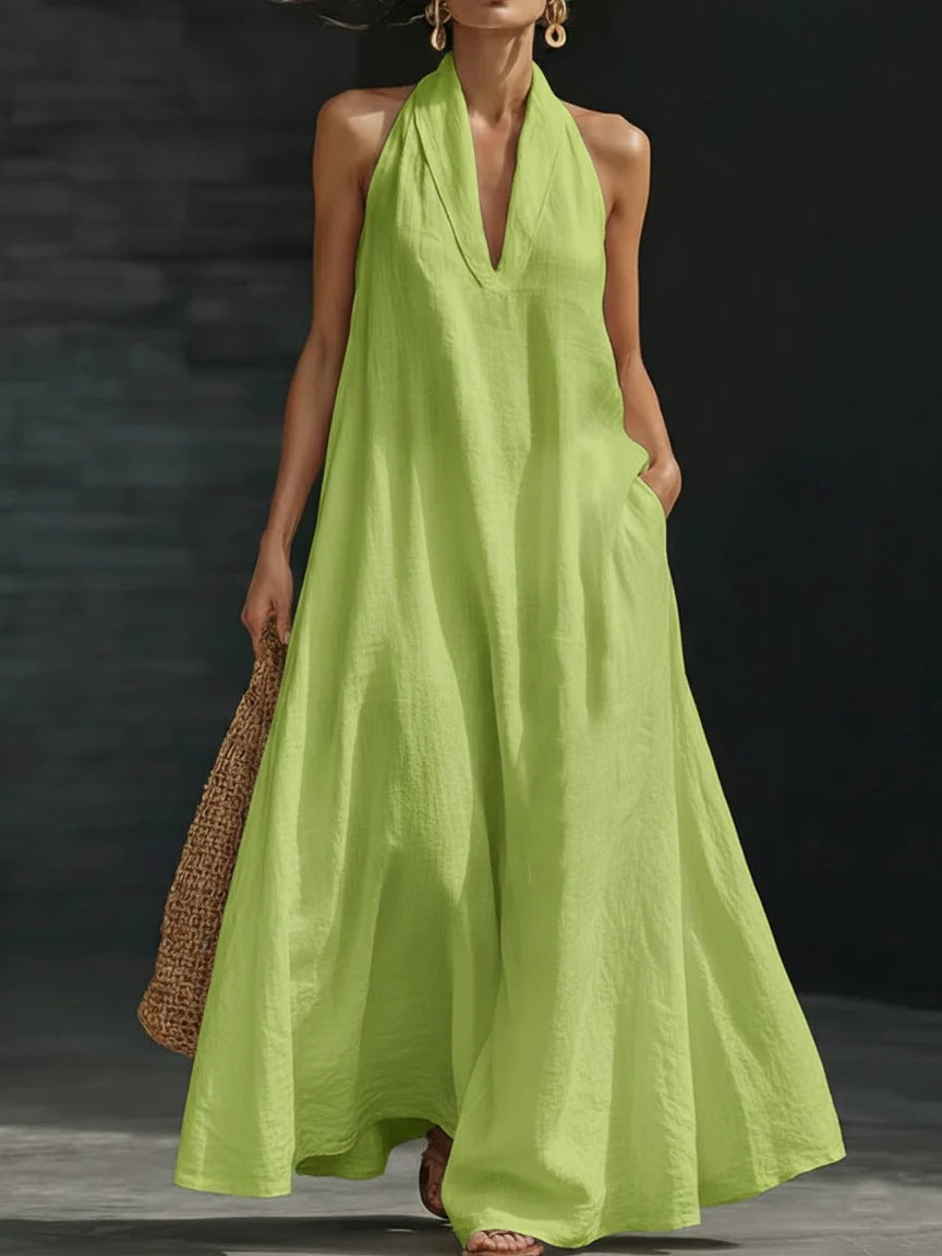 Woman wearing a long green dress against a dark background