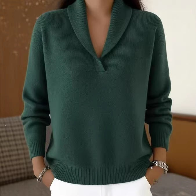 Person wearing a green sweater with a blurred background