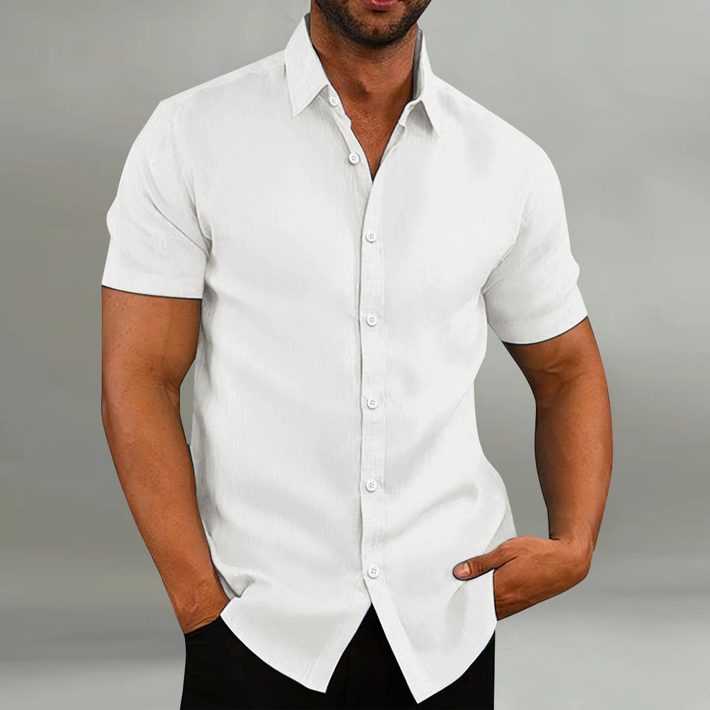 Man wearing a white short-sleeve dress shirt against a gray background