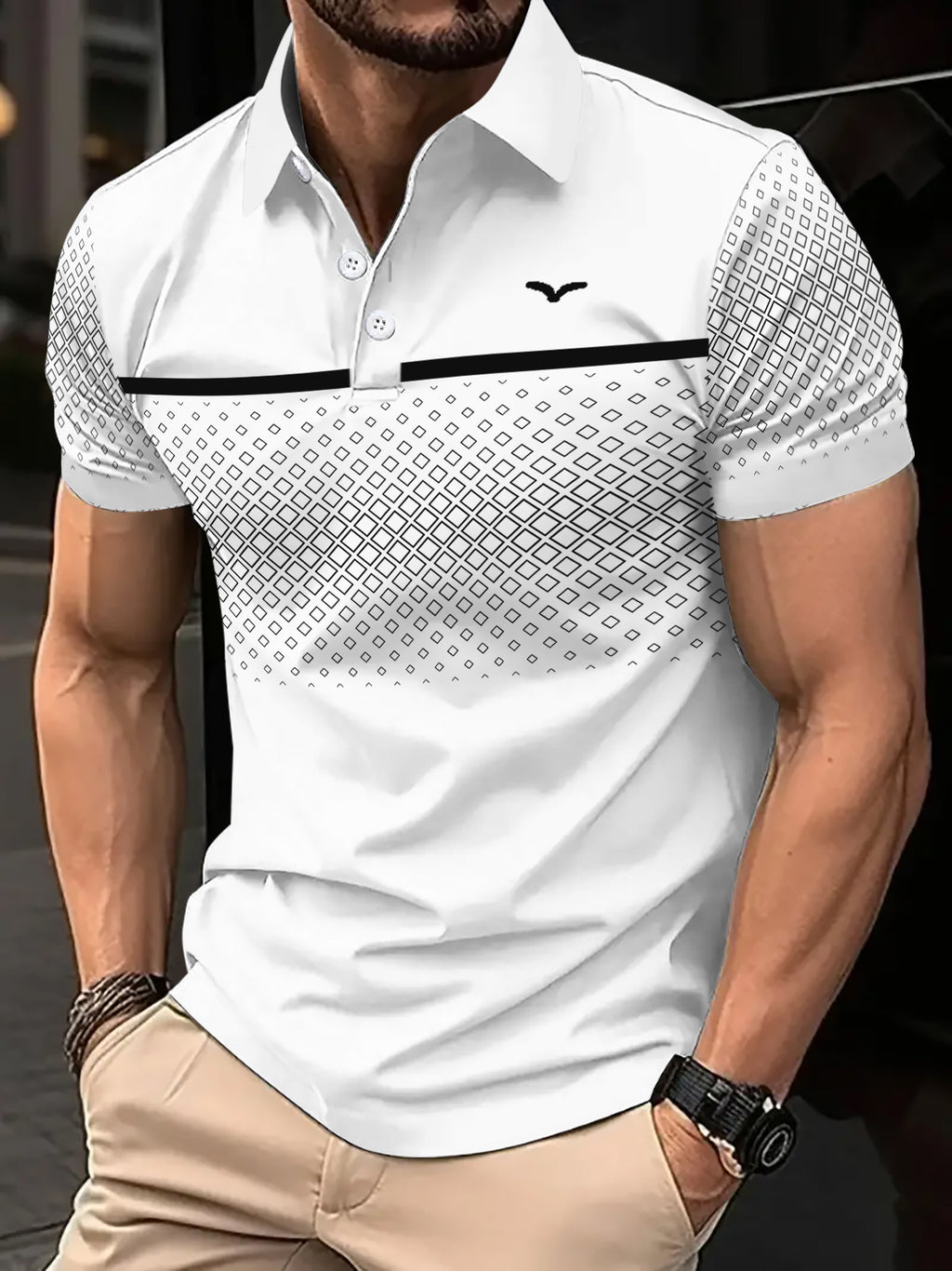 Man wearing a white patterned polo shirt with a blurred background