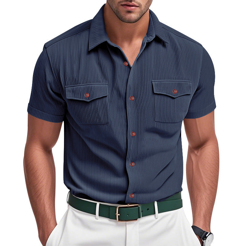 Man wearing a navy short-sleeve shirt with red buttons on a white background