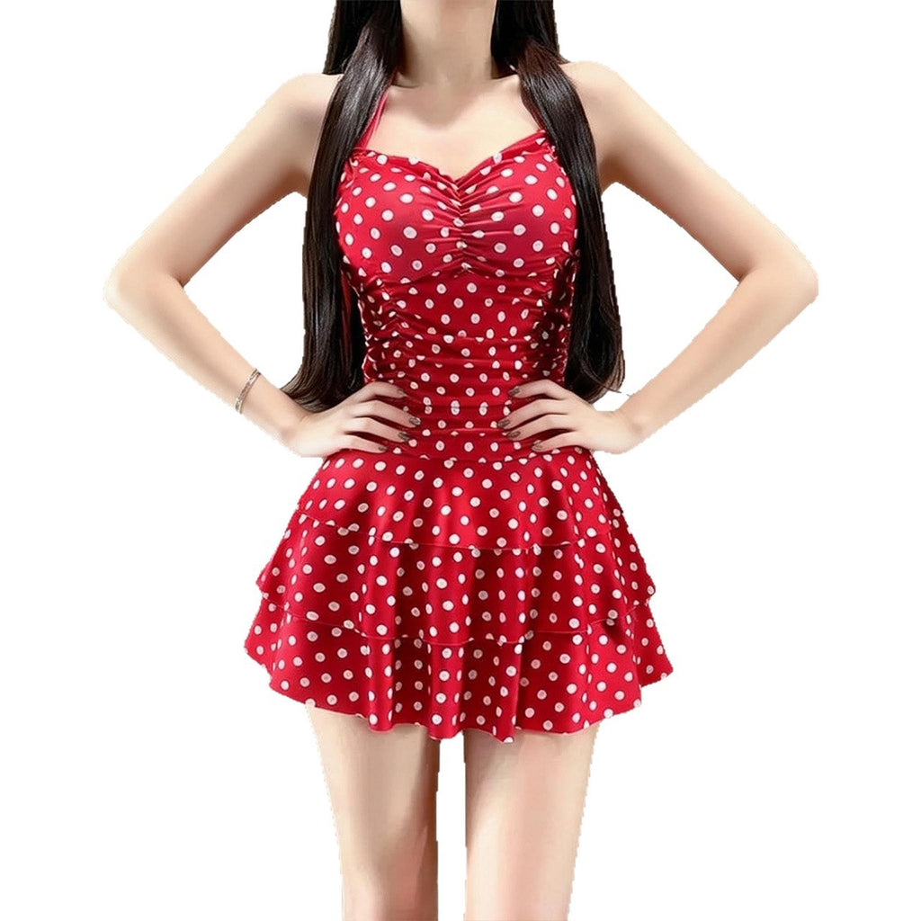 Red polka dot dress worn by a model on a white background