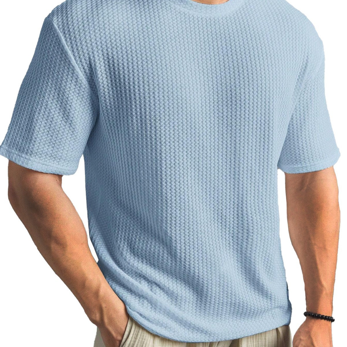 Light blue textured t-shirt worn by a person on a white background