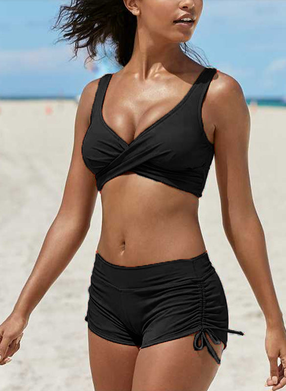 Woman wearing a black bikini on a beach