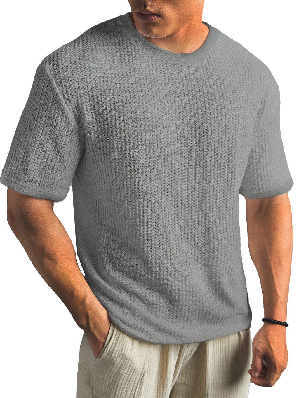 Man wearing a textured gray t-shirt on a white background