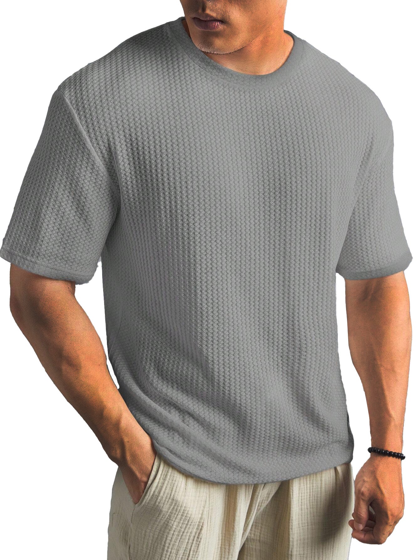 Man wearing a textured gray t-shirt on a white background