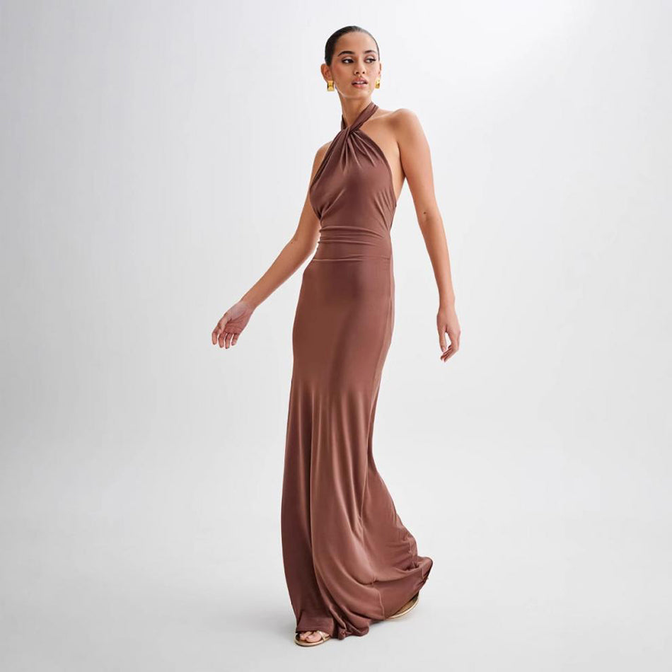 Woman wearing a brown halter neck gown on a white background