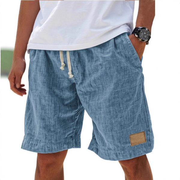 Blue shorts worn by a person on a white background