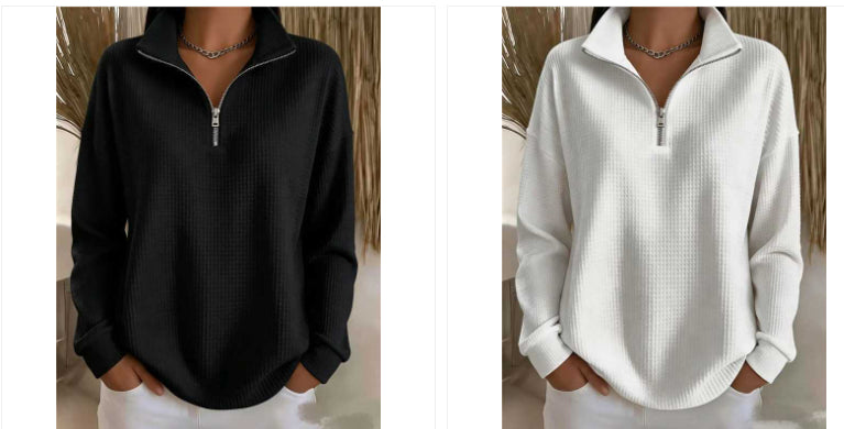 Two women's quarter-zip long-sleeve pullover tops shown side by side, one in black and one in white, both with a waffle texture and stand collar.