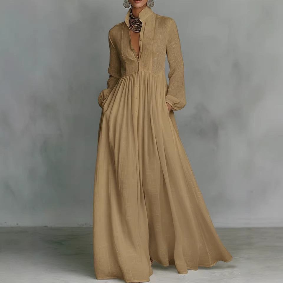 Long beige dress with a high neckline and long sleeves on a gray background