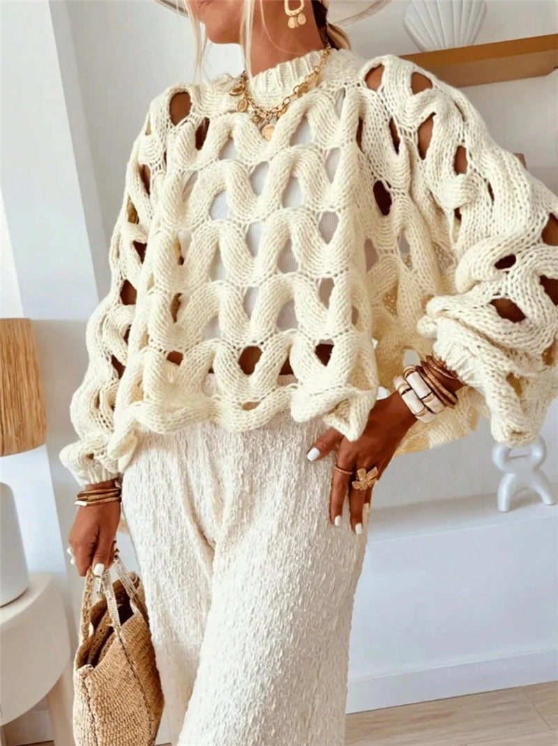 Person wearing a cream-colored knit sweater and pants indoors.
