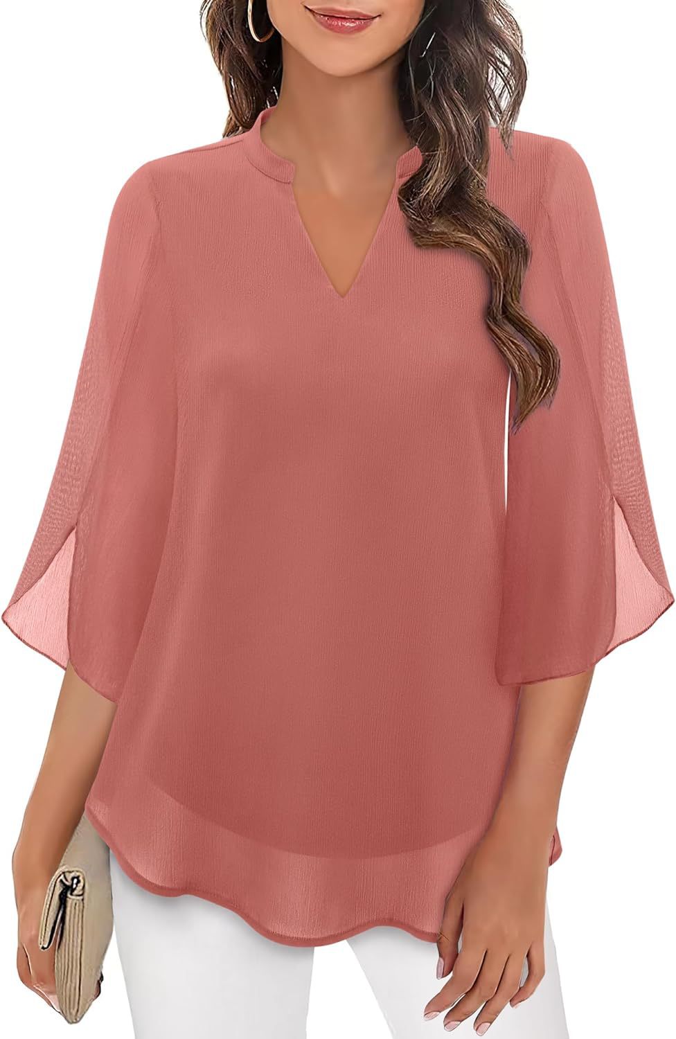 Woman wearing a pink blouse with sheer sleeves on a white background