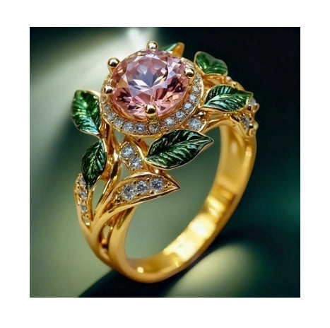 Gold ring with pink gemstone and green leaves on a dark background