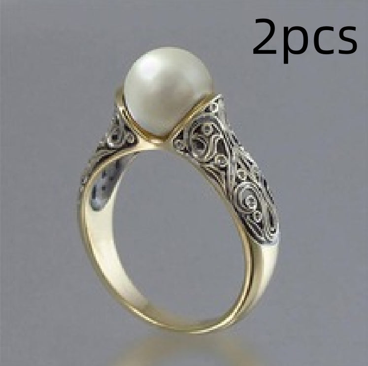 Gold ring with a pearl on a gray background