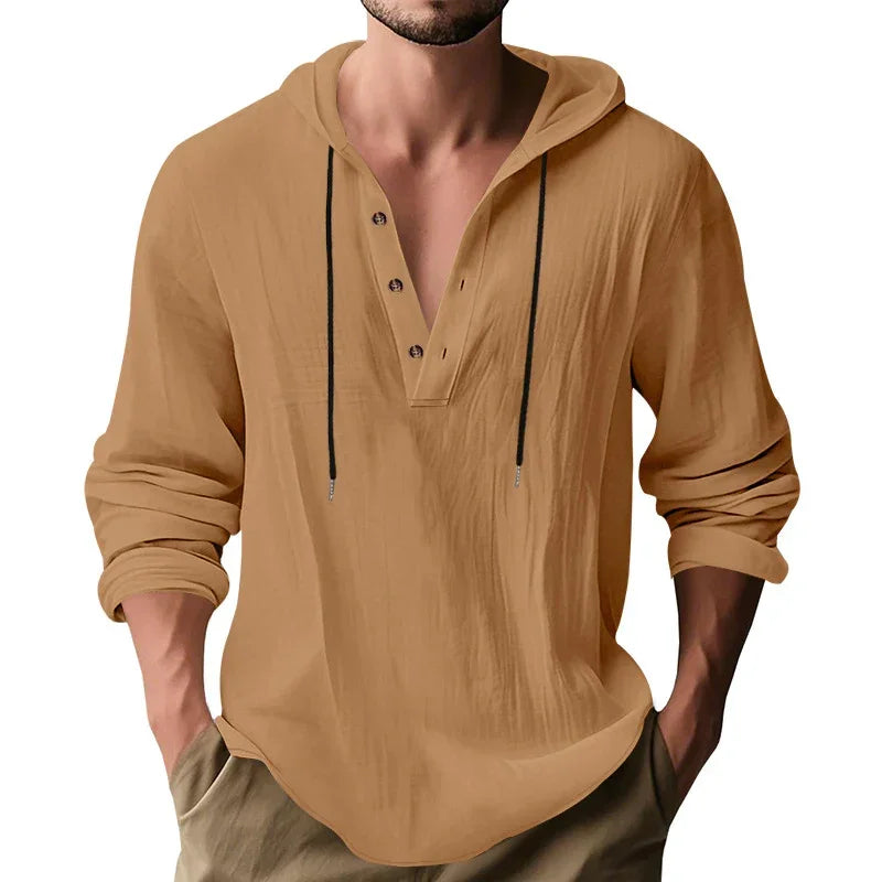 Man wearing a beige long-sleeve shirt with a deep V-neck on a white background