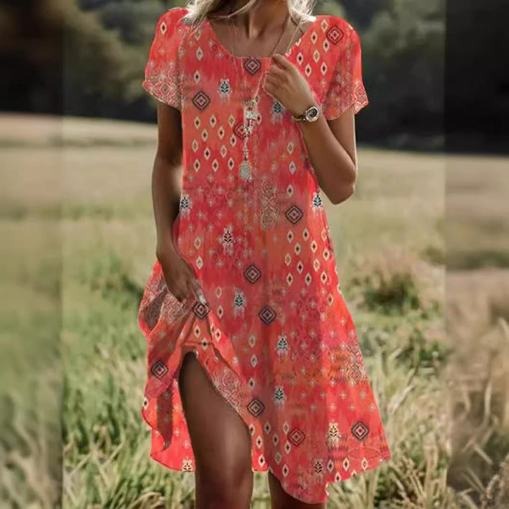 Woman wearing a red patterned dress standing in a natural setting