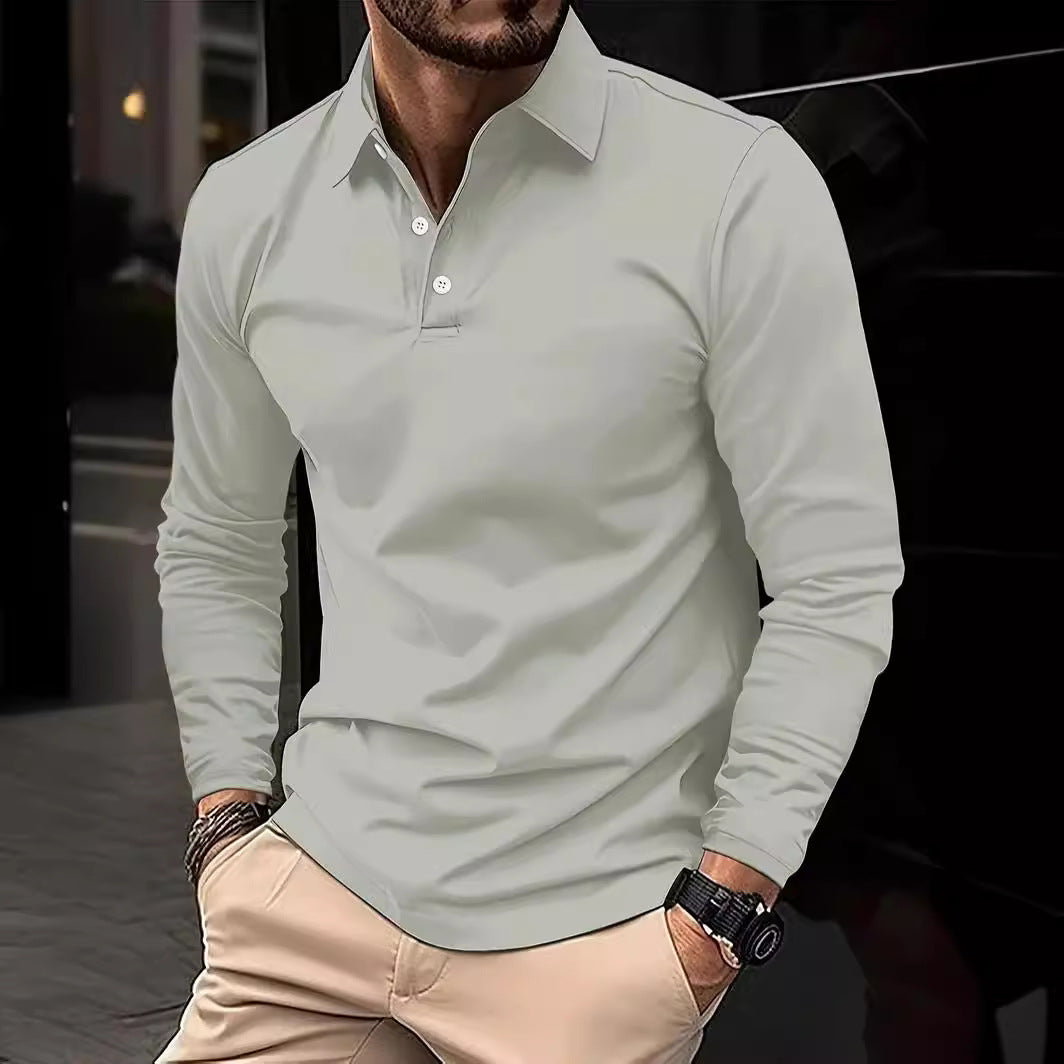Man wearing a light gray long-sleeve polo shirt and beige pants against a dark background
