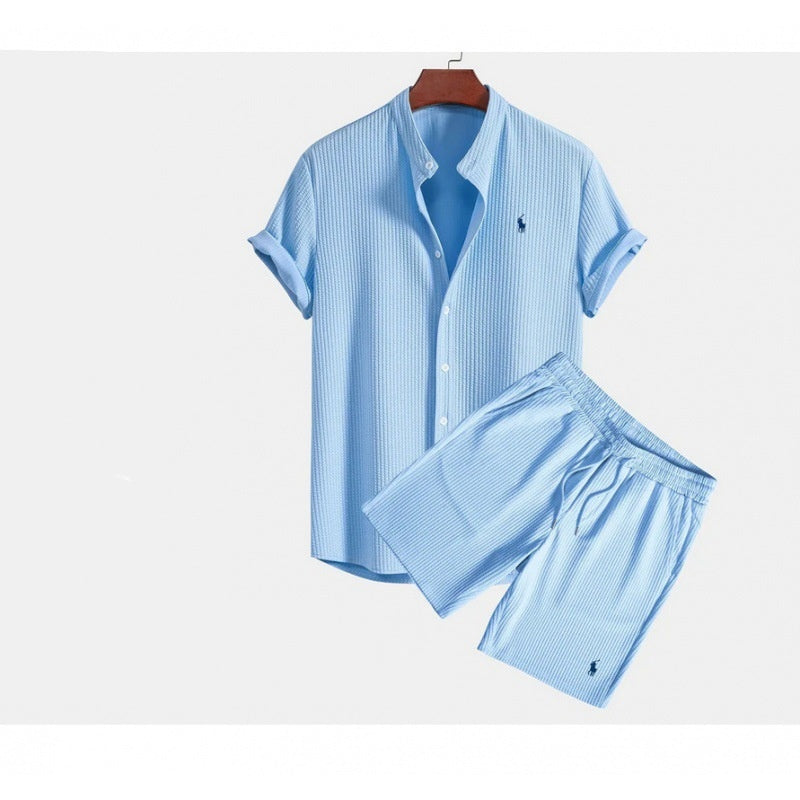 Light blue striped shirt and shorts set on a hanger with a white background
