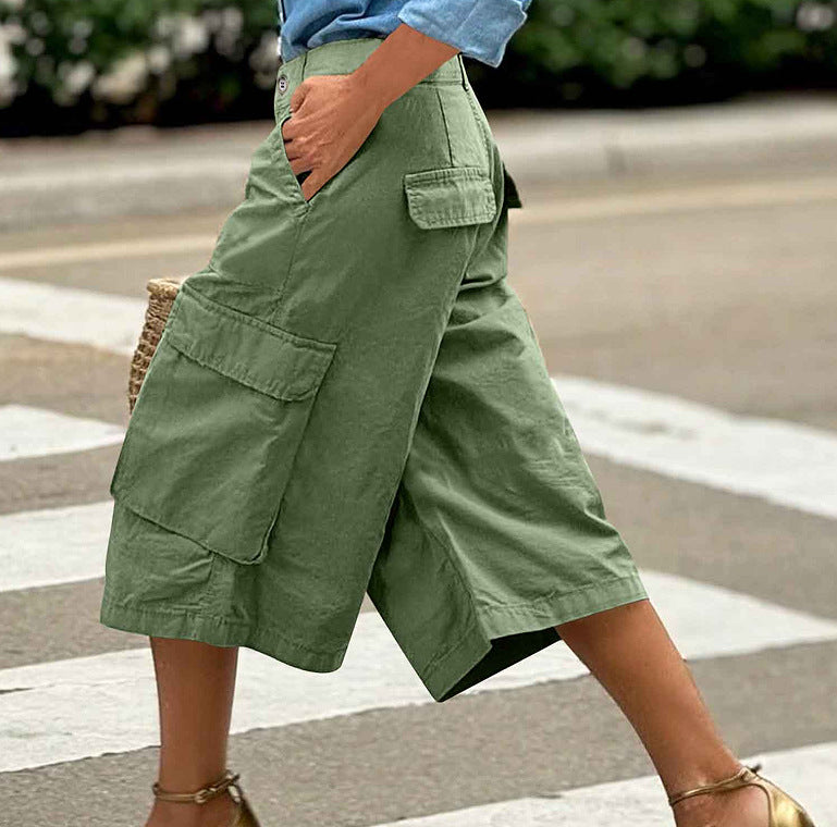 Green cargo shorts worn by a person on a street.