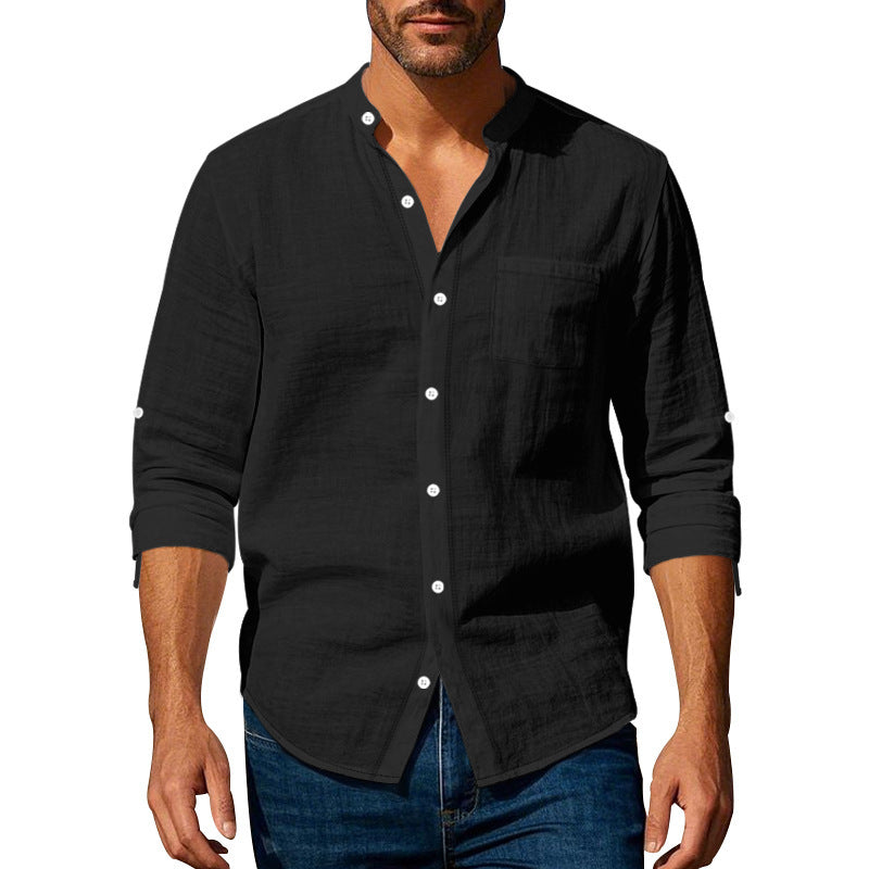 Man wearing a black button-up shirt with long sleeves on a white background