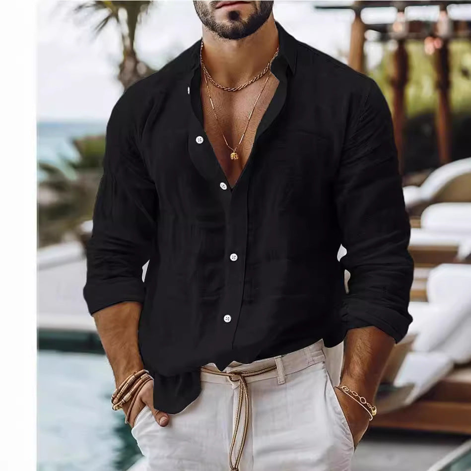 Man wearing a black shirt and white pants with a blurred background