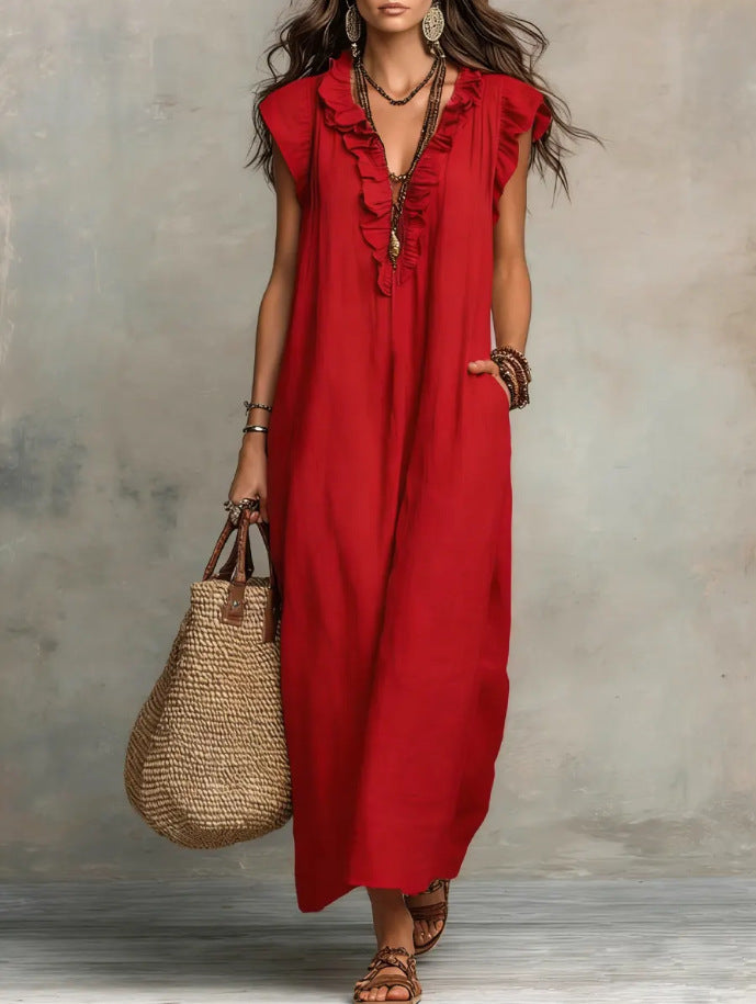 Woman wearing a red dress holding a straw bag against a neutral background