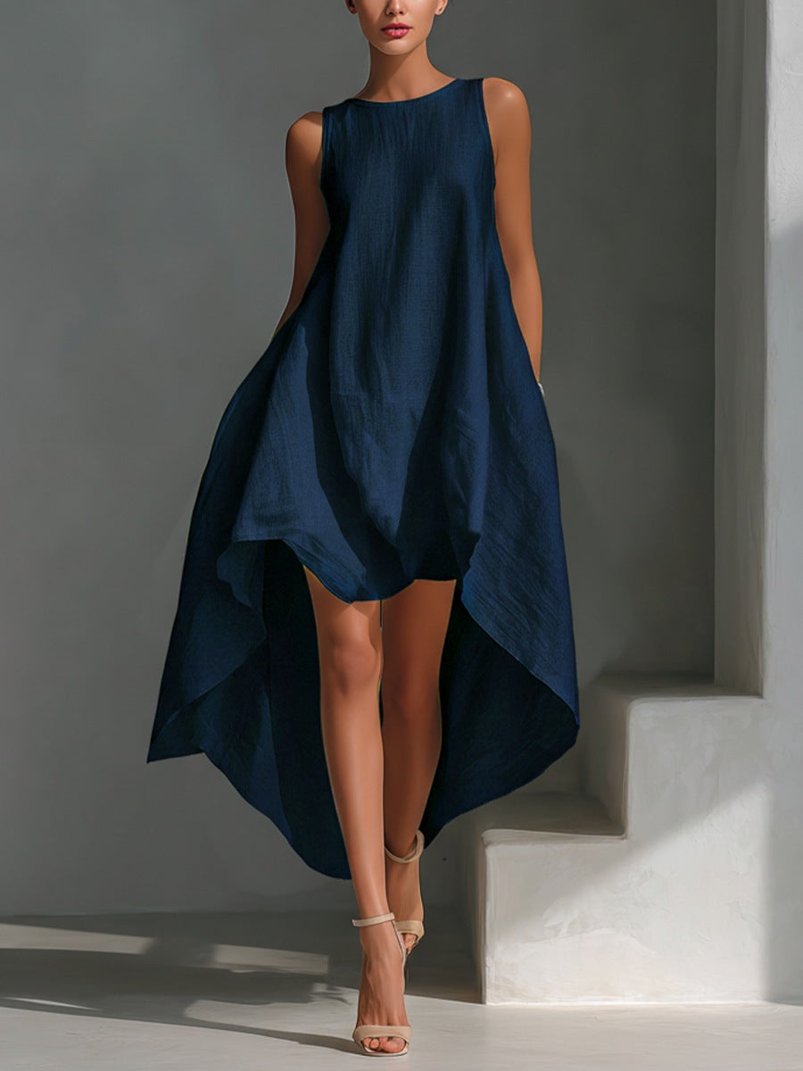 Woman wearing a navy blue sleeveless dress against a gray background
