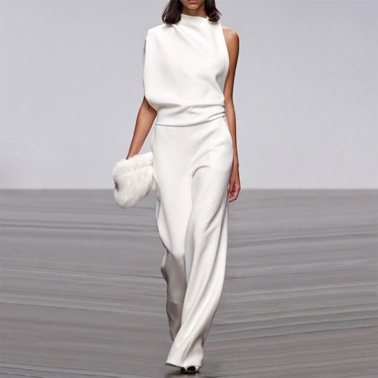 Person wearing a white outfit with a plain background