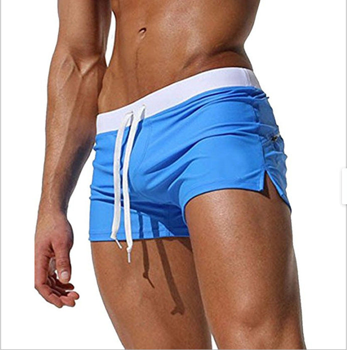 Blue swim shorts with white drawstring on a white background