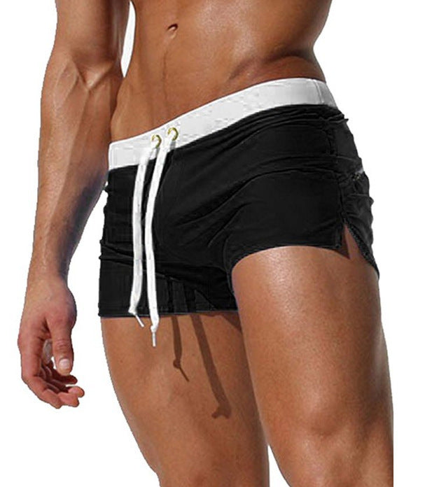 Black swim shorts with white drawstring on a white background