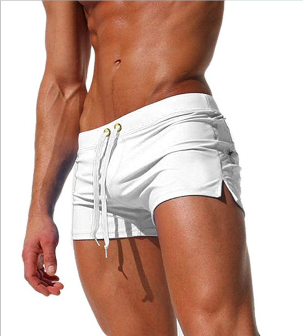 White swim shorts worn by a person on a white background