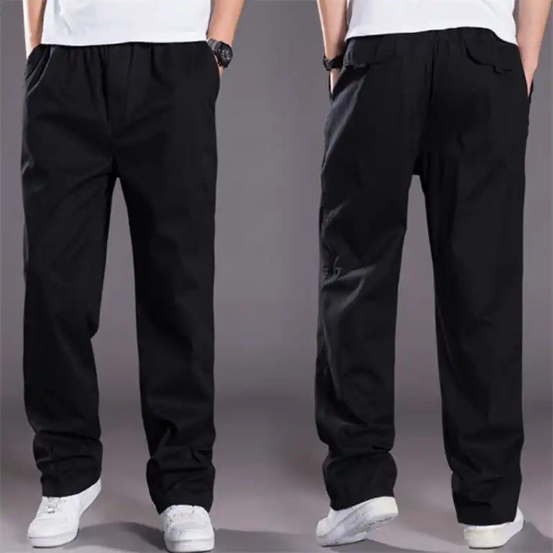 Black pants worn by a person on a gray background