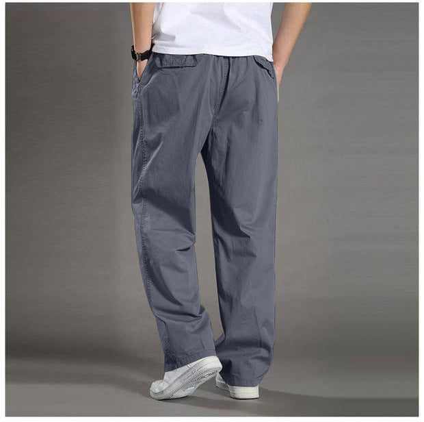 Person wearing gray pants on a plain background
