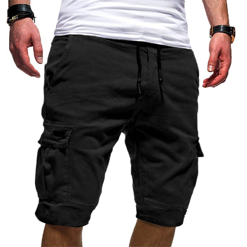 Black cargo shorts worn by a person on a white background
