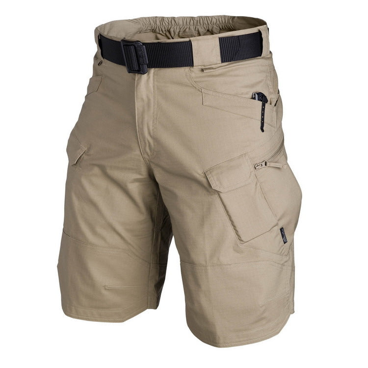 Beige tactical shorts with multiple pockets and a belt on a white background