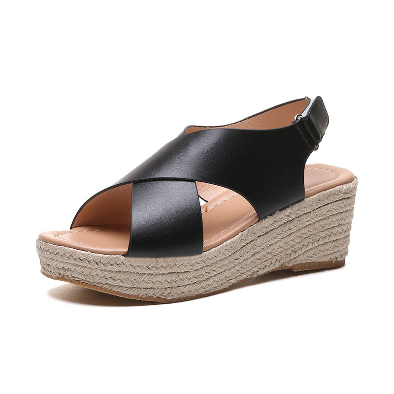 Black wedge sandal with espadrille sole on a white background