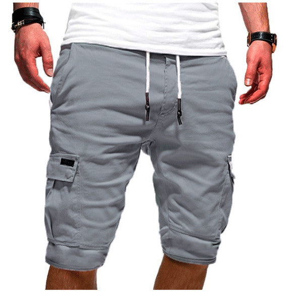 Gray cargo shorts worn by a person on a white background