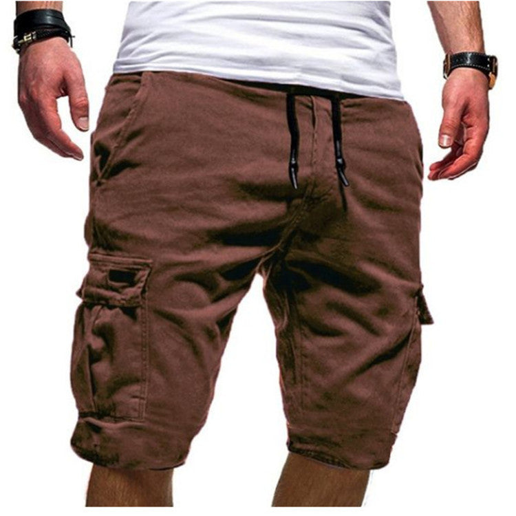 Brown cargo shorts worn by a person on a white background