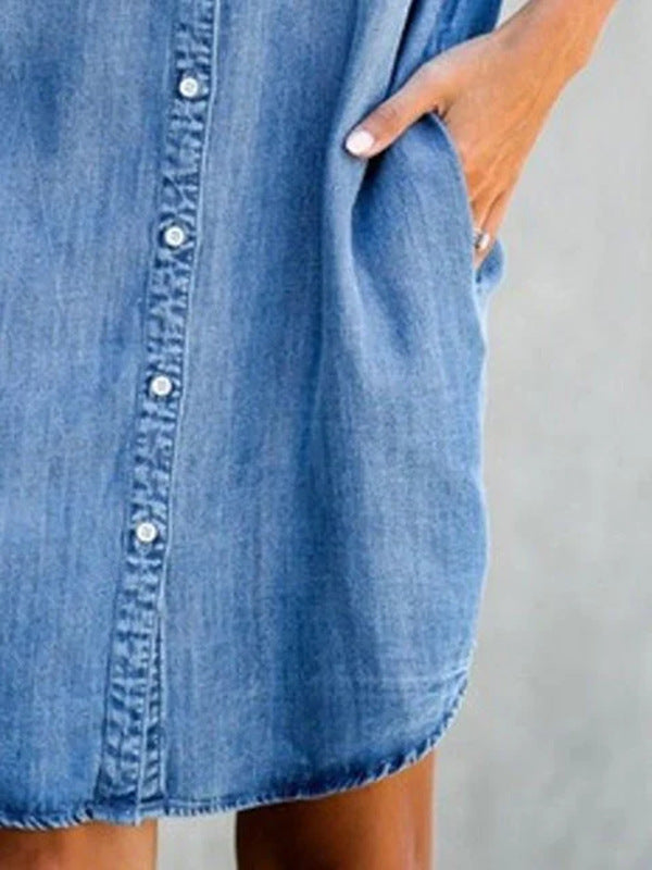 Blue denim dress worn by a person with a neutral background