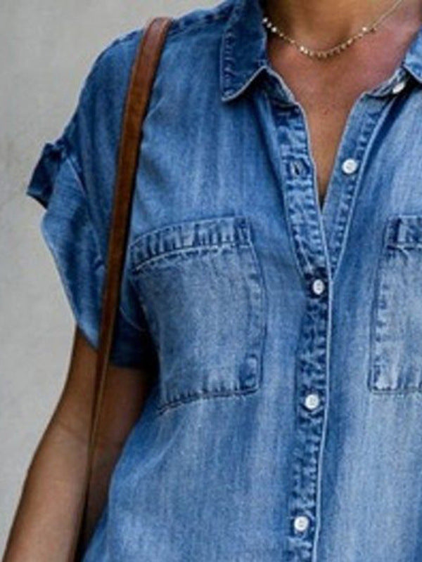 Close-up of a person wearing a blue denim shirt with a neutral background