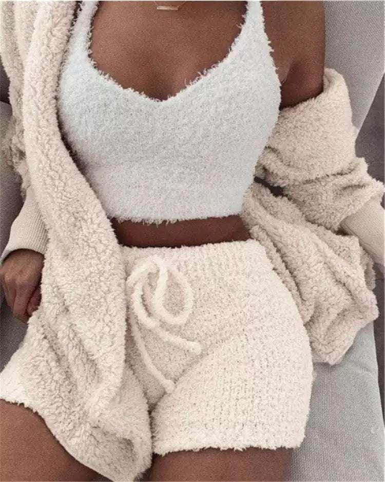 Woman wearing a cozy beige fluffy knit lounge set with shorts, cardigan, and crop top