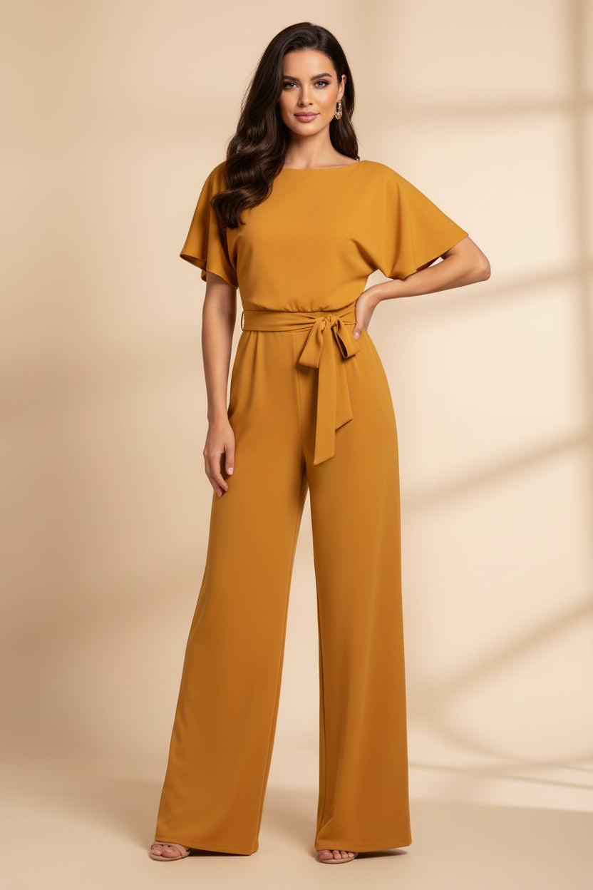 Woman wearing a bright orange jumpsuit on a white background