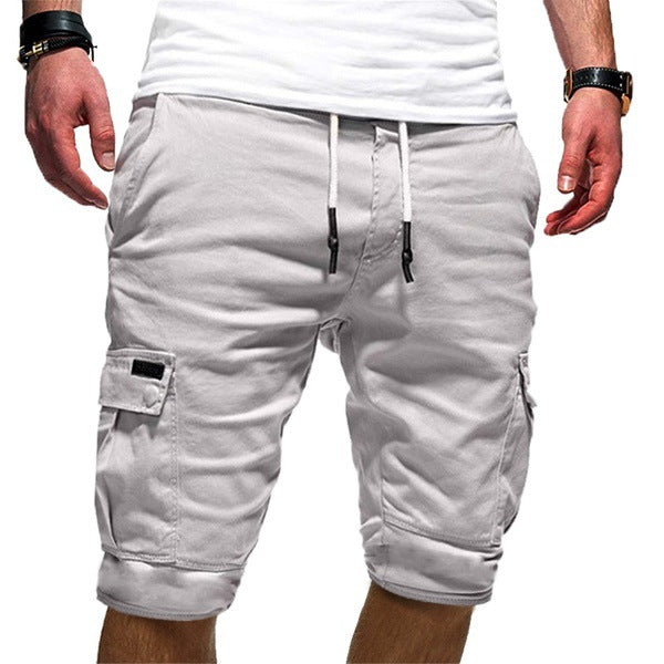 Light gray cargo shorts worn by a person on a white background