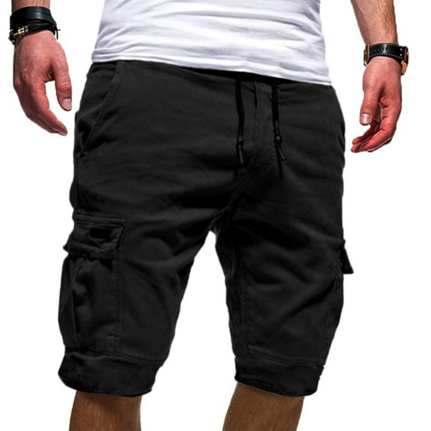 Black cargo shorts worn by a person on a white background