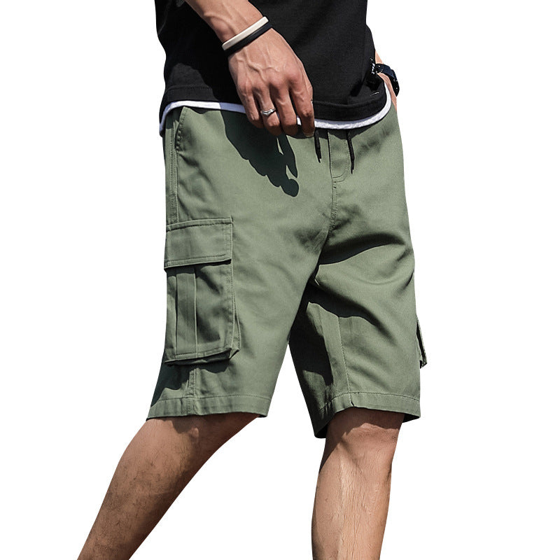 Green cargo shorts worn by a person on a white background