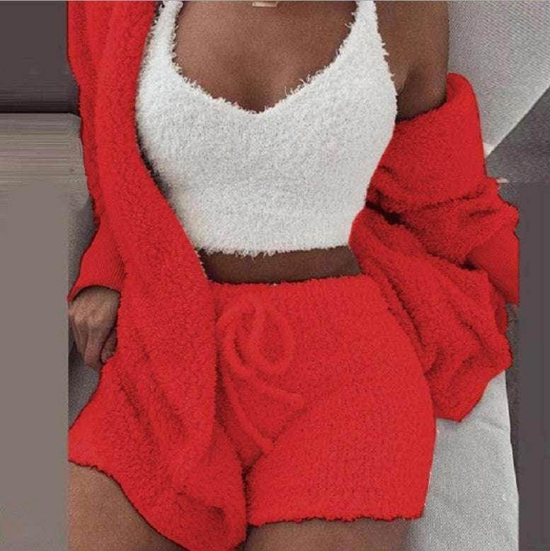 Woman wearing a white fuzzy crop top with matching red fuzzy cardigan and shorts from ZA-Zola fashion